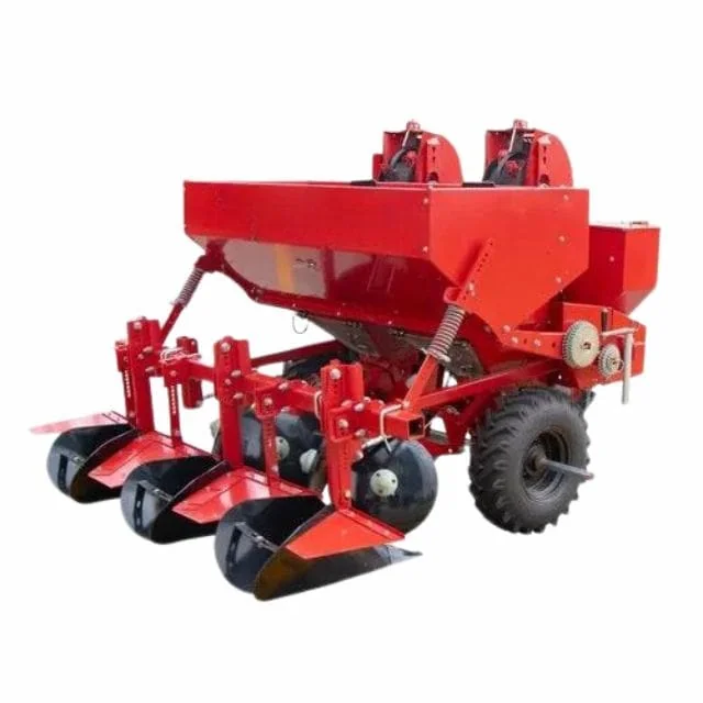 Red potato planter with hoppers, wheels and soil-working parts on a plain background